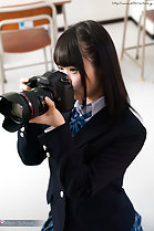 Student looking through viewfinder in classroom
