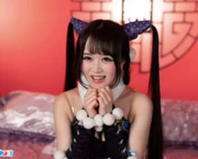 Ria Kurumi in cheongsam kneeling on bed