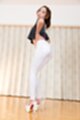 Standing in hotpants looking over her shoulder wearing white high heels