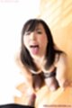 Tongue extended long hair falling over her breasts wearing stockings