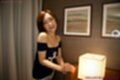 Standing beside light wearing off the shoulder top