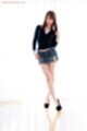 Wearing short skirt legs crossed high heels
