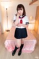 Kogal standing beside bed wearing uniform
