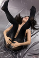 Spreading her pussy in black pantyhose legs raised long hair splayed out on sheet.jpg
