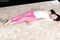 Miyazaki Yuma lying on her back in pink stockings silver high heels at her feet