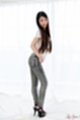 Long hair falling over her top wearing jeans in high heels