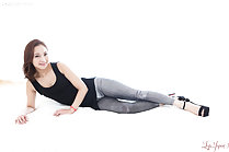 Uika Hoshikawa lying on her side in jeans wearing high heels