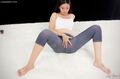 Yukishiro madoka seated with legs spread wearing leggings hand on her pussy