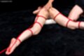 Maeshiro shizuka on her front tied up nude with red shibari rope