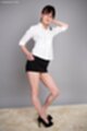 Hand on hip black skirt high heels