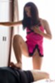 Standing beside curtained window wearing lingerie giving footjob bare feet