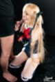 On her knees sucking cock head