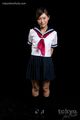 Student standing in uniform hands behind her back