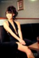 Seated wearing dress hands clasped