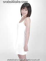Standing in white slip arms down by her side short hair